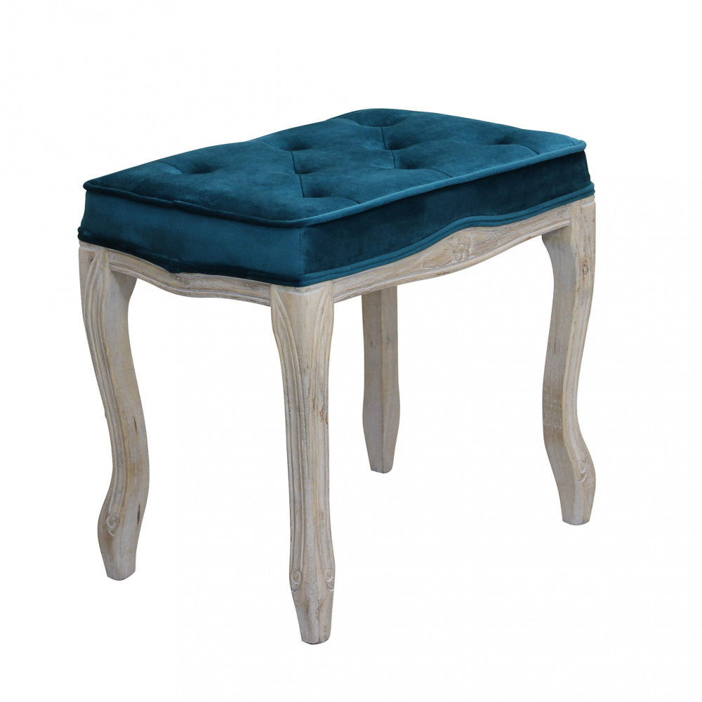 Vista angolare dello sgabello Marly che mostra le gambe in legno intagliato e la seduta capitonné.