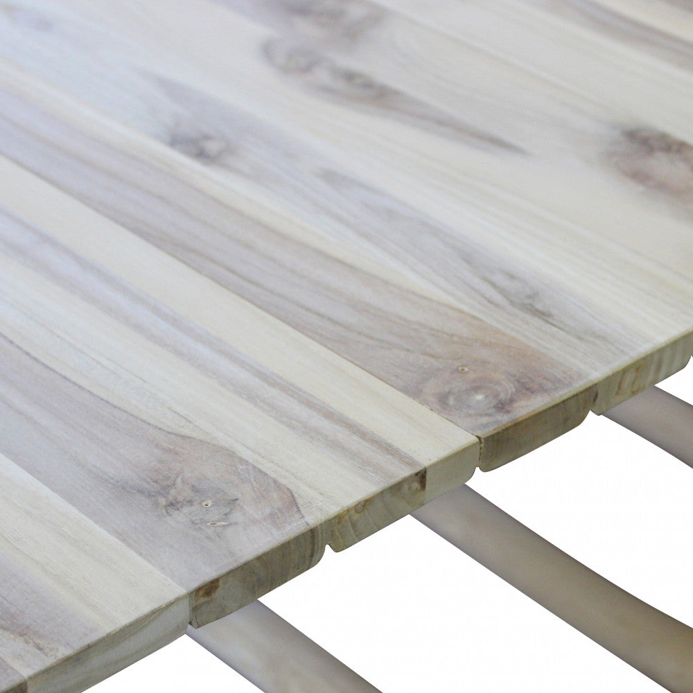 Tavolino Martinez in teak chiaro con venature naturali, posizionato in un ambiente esterno.