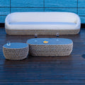 Tavolino Ovale Lafayette con struttura in alluminio e rivestimento in corde beige, in un ambiente esterno.