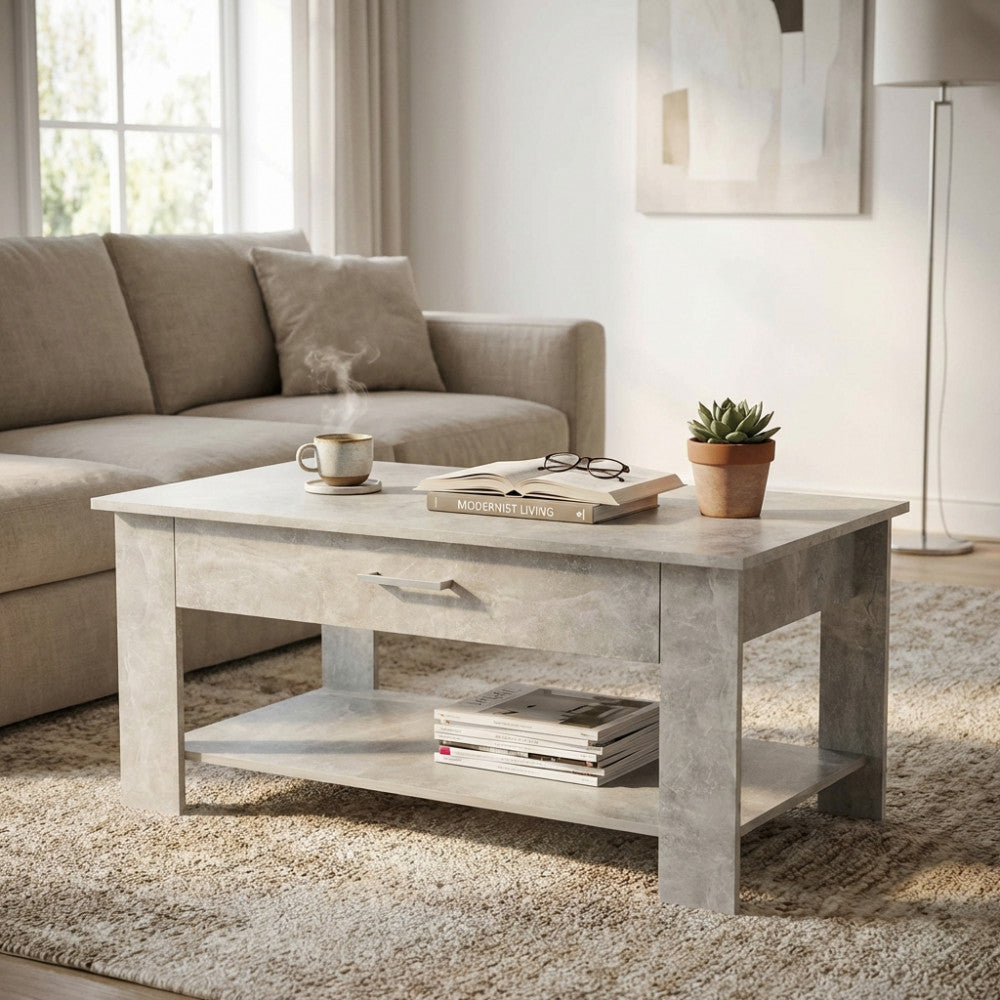 Tavolino da salotto moderno in bilaminato grigio posizionato in un luminoso soggiorno con divano beige e pianta decorativa.