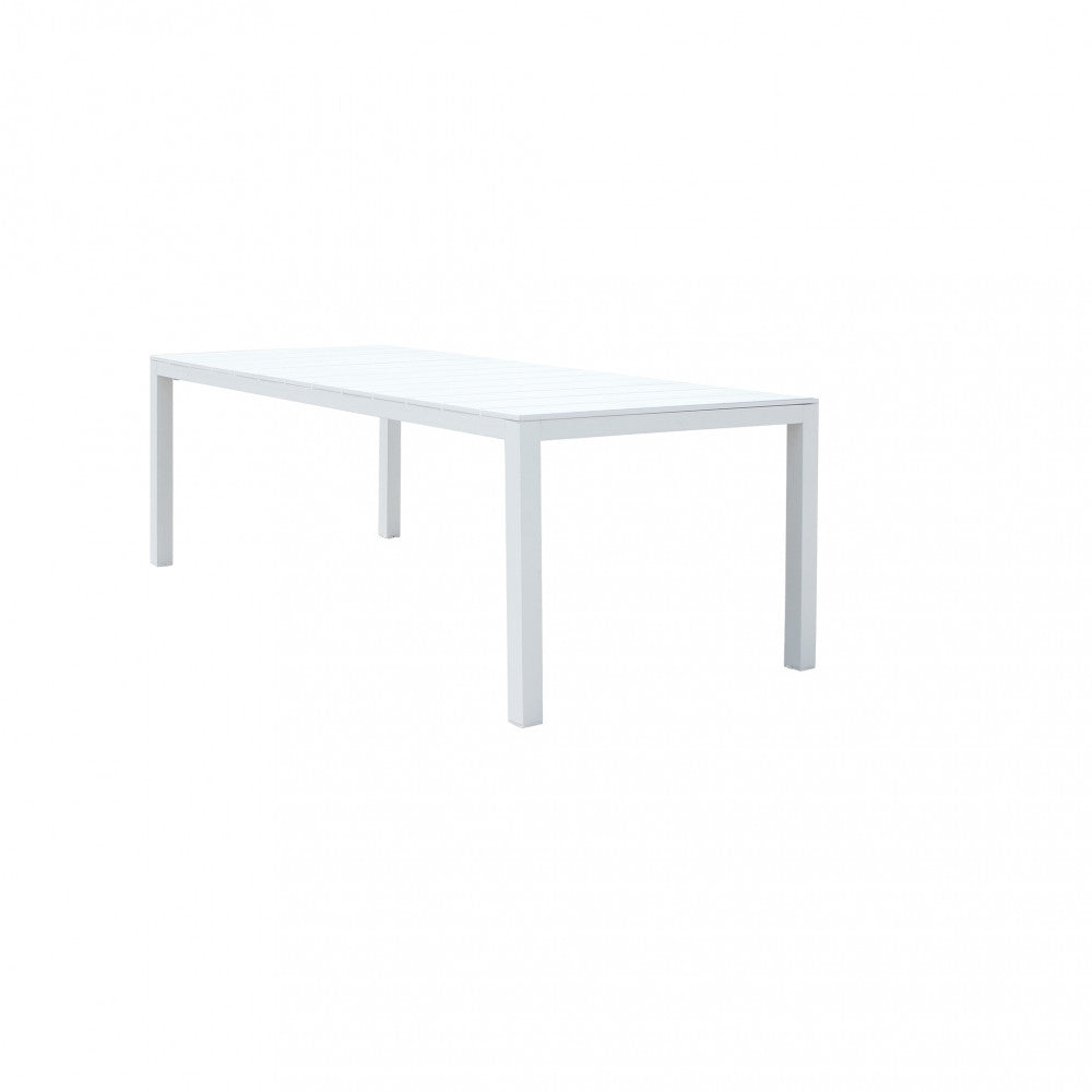 Tavolo rettangolare allungato su un terrazzo apparecchiato per una grande cena.