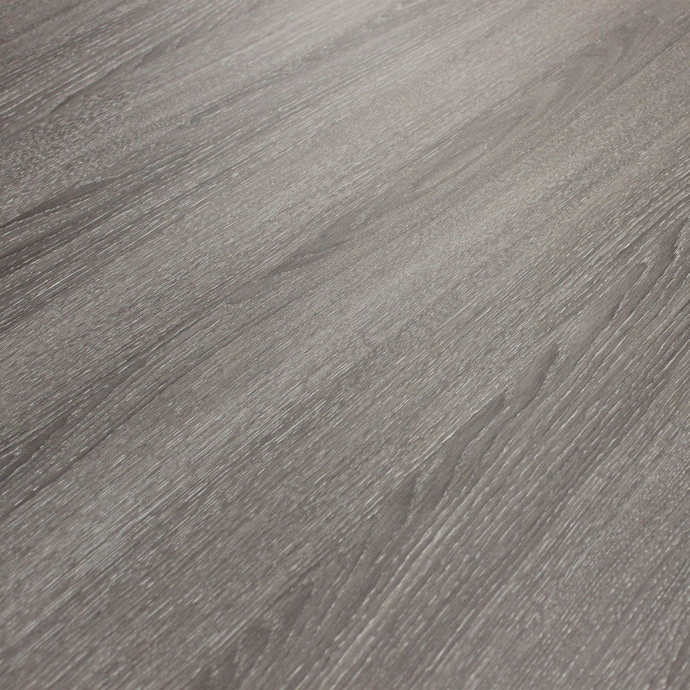 Dettaglio ravvicinato della texture in melaminico grigio scuro del tavolo Garfield.