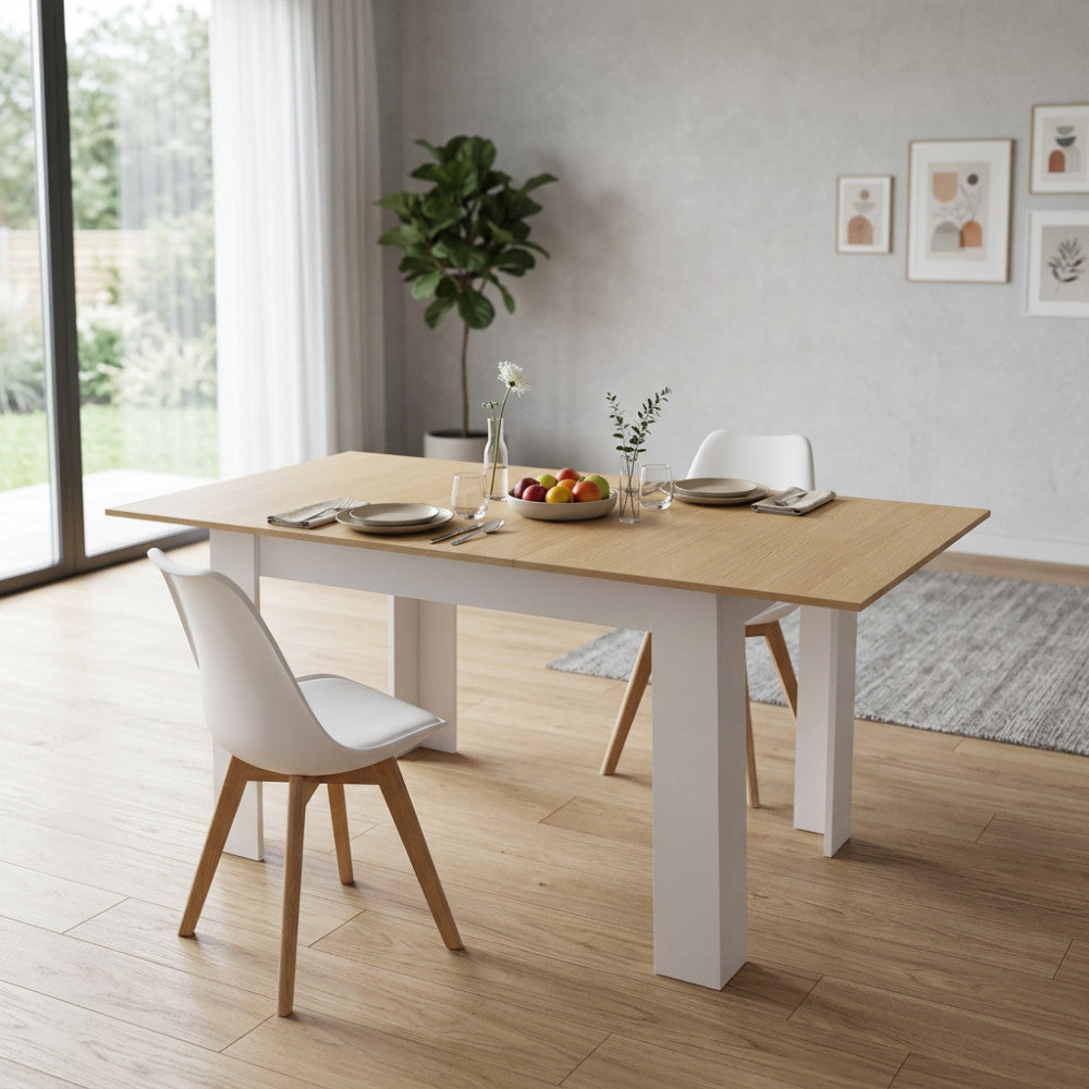 Tavolo moderno Archibald con piano in legno esteso, decorato con un cesto di frutta in un ambiente neutro.