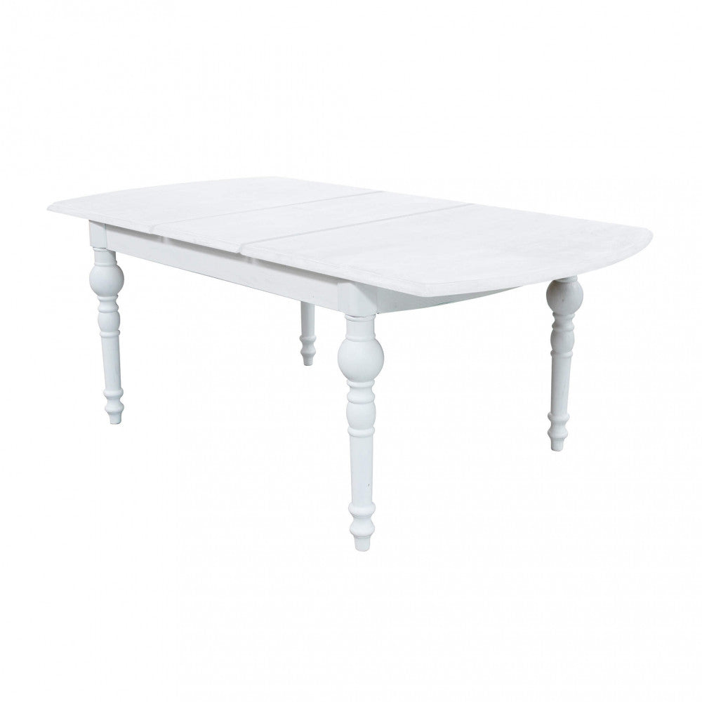 Prospettiva angolare del tavolo da pranzo in legno bianco, con il piano chiuso e le gambe classiche in evidenza.