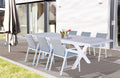 Tavolo da giardino Djerba in alluminio bianco e gres allestito su un patio in legno con sedute coordinate.