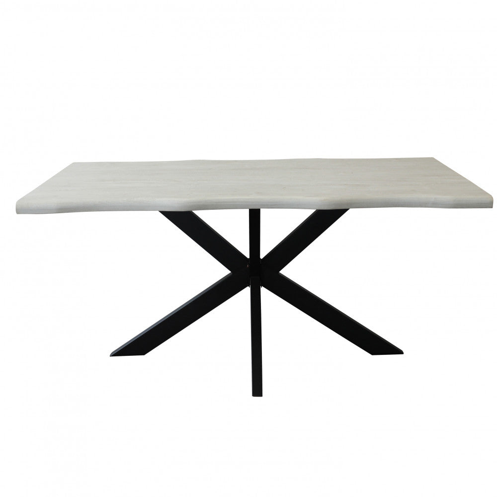 Vista frontale del tavolo Floyd, che mette in risalto il design architettonico delle gambe incrociate in metallo nero.