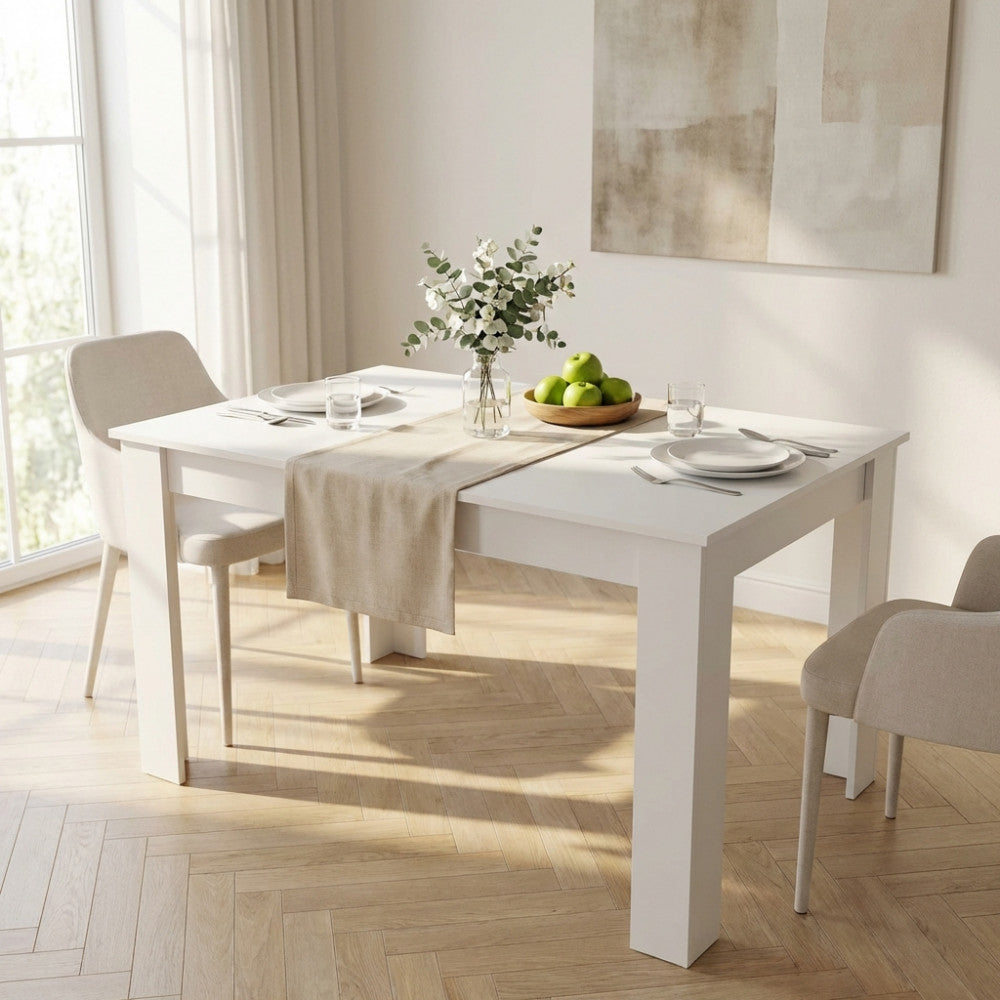 Tavolo da pranzo Pepper bianco allestito con runner in lino, mele verdi e stoviglie bianche in una stanza luminosa.