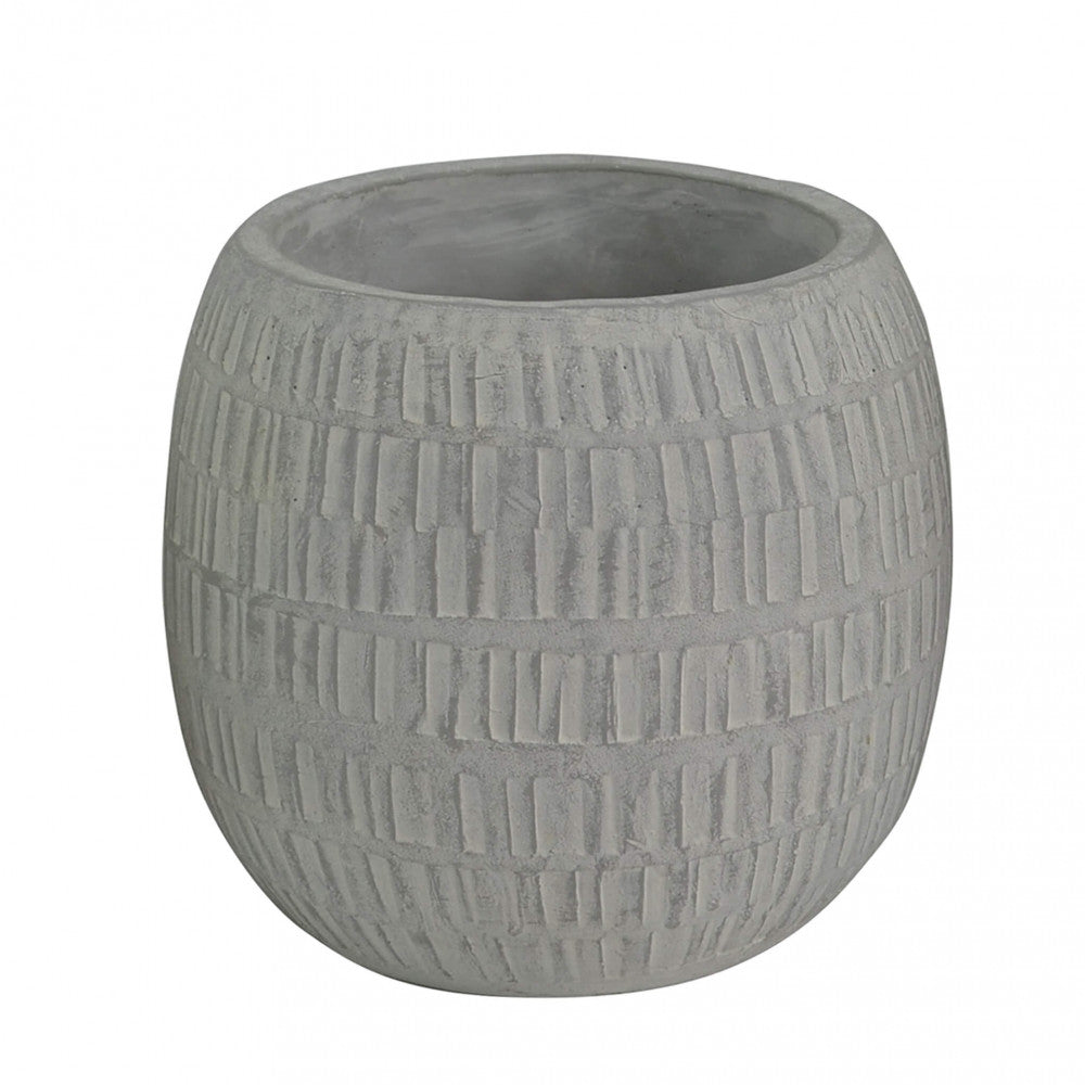 Dettaglio ravvicinato della complessa texture geometrica incisa sulla superficie del vaso in fibra sintetica.