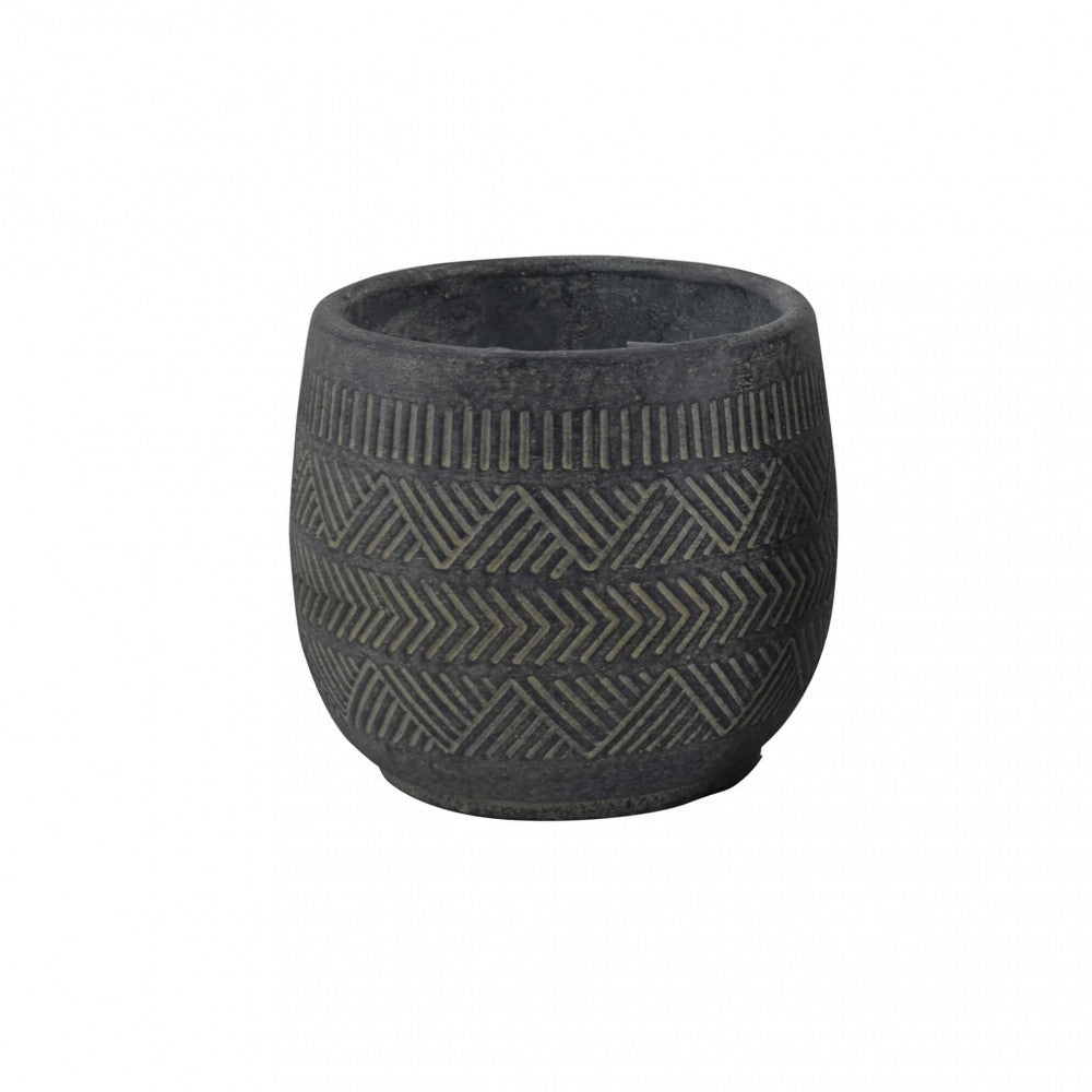 Dettaglio frontale del vaso vuoto in fibra sintetica con pattern a spina di pesce e finitura materica.